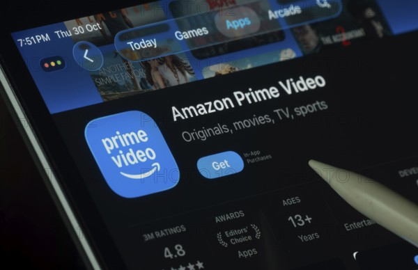 Dhaka, Bangladesh- 30 Oct 2025: Amazon Prime Video app displayed on a iPad screen in dark mode with a digital pen pointing at it