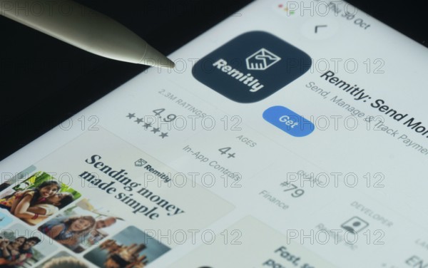 Dhaka, Bangladesh- 30 Oct 2025: Remitly app on a iPad screen with a pen pointing at the install option