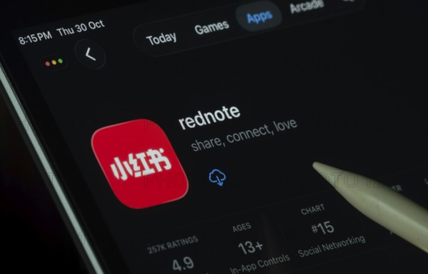 Dhaka, Bangladesh- 30 Oct 2025: rednote app displayed on a iPad screen in dark mode with a digital pen pointing at it