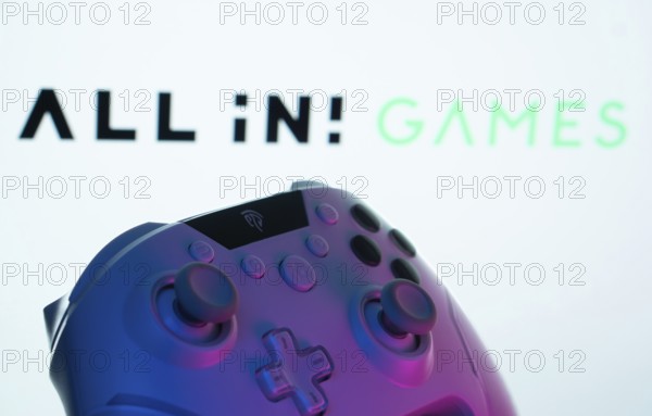 Dhaka, Bangladesh- 20 Mar 2025: A close-up of a gamepad with the All in! Games seen on screen in the background