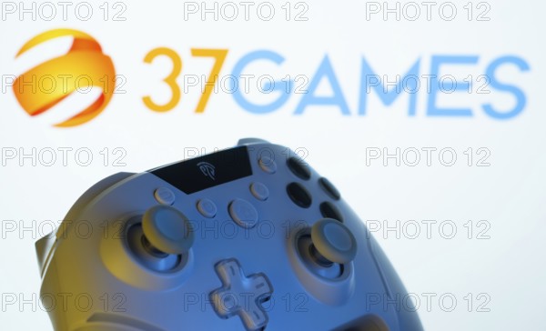 Dhaka, Bangladesh- 20 Mar 2025: A close-up of a gamepad with the 37Games seen on screen in the background