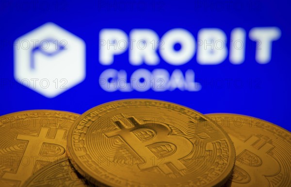 Dhaka, Bangladesh- 27 Mar 2025: Close-up of Bitcoin coins with the ProBit Global logo visible on a screen in the background