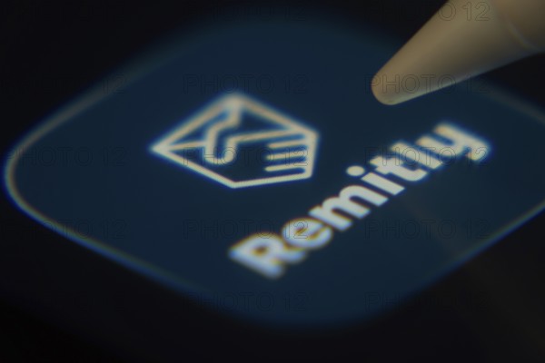 Dhaka, Bangladesh- 06 Dec 2025: Close-up of the Remitly app on a screen with a stylus pointing at it