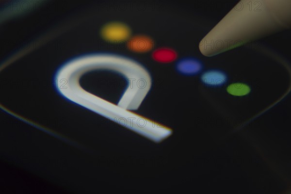 Dhaka, Bangladesh- 06 Dec 2025: Close-up of the Peacock TV app on a screen with a stylus pointing at it