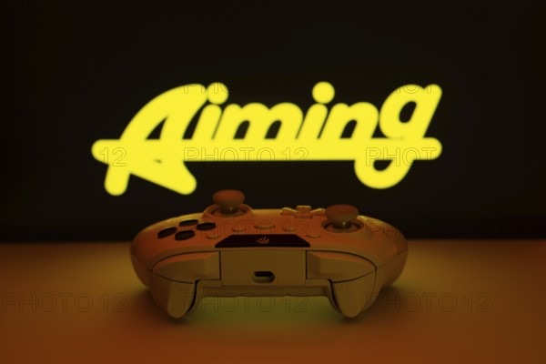 Dhaka, Bangladesh- 08 Apr 2025: A gaming controller in front of a Aiming Inc screen