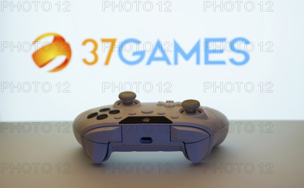 Dhaka, Bangladesh- 08 Apr 2025: A gaming controller in front of a 37Games screen