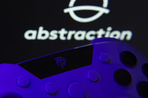 Dhaka, Bangladesh- 24 Mar 2025: A close-up of a gamepad with the Abstraction seen on screen in the background