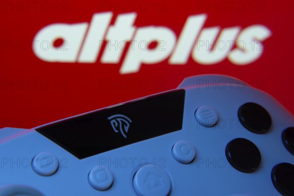 Dhaka, Bangladesh- 24 Mar 2025: A close-up of a gamepad with the altplus seen on screen in the background