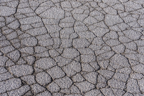Asphalt surface, floor, with many small cracks, roadway, parking lot