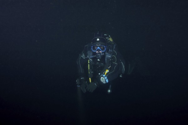 Divers at night in Lake Walen. Tauchplatz Känzeli, Mols, Canton of St. Gallen, Switzerland