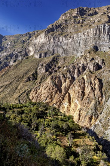 Large, steep rock walls with natural geological patterns, The landscape of the Colca Canyon in the Aden of Peru