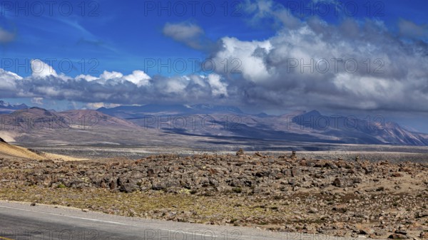 Rugged desert landscape with mountains and cloudy background in the distance, The highlands of the Andes of Peru