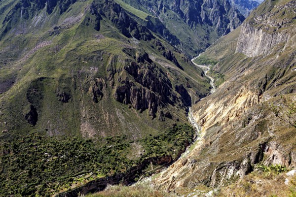 Impressive gorge in a far-reaching mountain landscape under blue skies, The landscape of Colca Canyon in the Aden of Peru