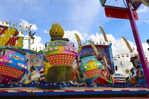 Fairground in Ulm Friedrichsau, folk festival, hustle and bustle, amusement park, amusement attraction, ride, blue sky, clouds, Ulm, Baden-Württemberg, Germany