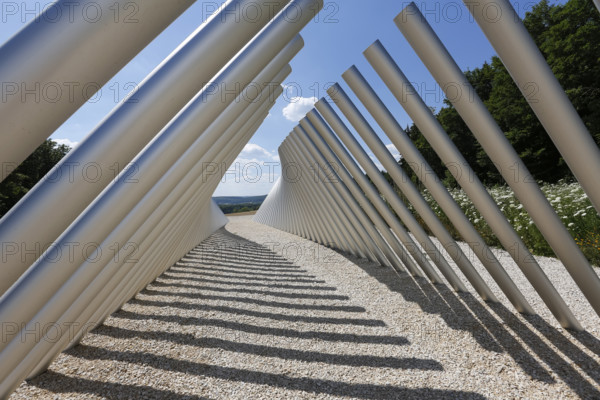 Art in public space, sculpture made of aluminum profile pipes by artist Martin Burchard, life's horizon path near Mundingen, light and shadow, gravel, clouds, blue sky, walk-in art, paths of reflection and refreshment on the Ehinger Alb, Baden-Württemberg, Germany