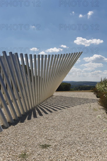 Art in public space, sculpture made of aluminum profile pipes by artist Martin Burchard, life's horizon path near Mundingen, light and shadow, gravel, clouds, blue sky, walk-in art, paths of reflection and refreshment on the Ehinger Alb, Baden-Württemberg, Germany