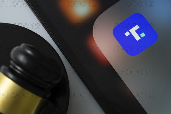 Dhaka, Bangladesh- 11 March 2025: A close up of an iPad screen displaying the Truth Social app alongside a judge's gavel