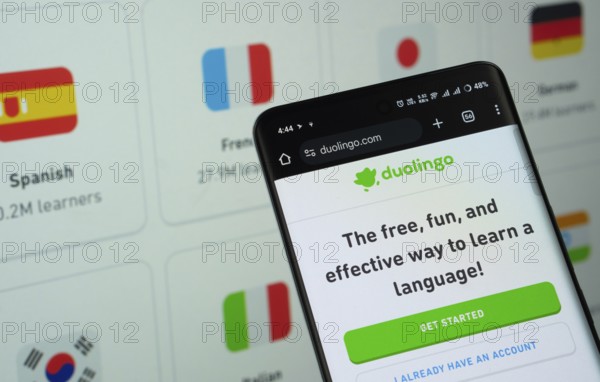 Dhaka, Bangladesh- 05 March 2025: Duolingo is displayed on a smartphone screen, with the website visible on a computer screen in the background