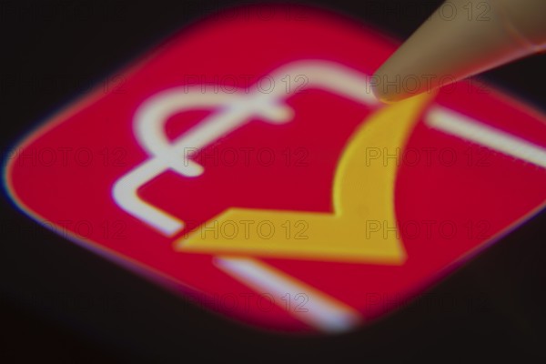 Dhaka, Bangladesh- 06 Dec 2025: Close-up of the AliExpress app on a screen with a stylus pointing at it