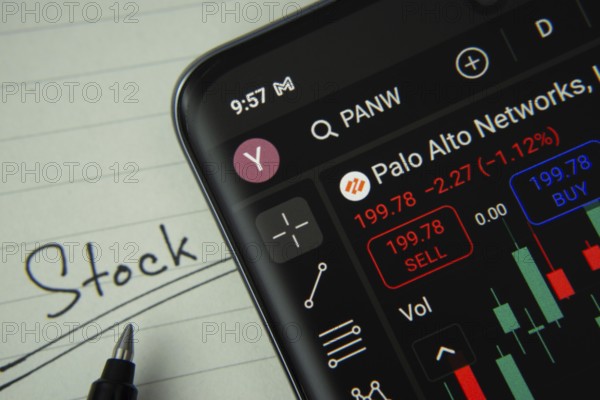 Dhaka, Bangladesh- 20 June 2025: Palo Alto stock trading information on smartphone screen with a handwritten note