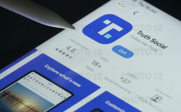 Dhaka, Bangladesh- 30 Oct 2025: Truth Social app on a iPad screen with a pen pointing at the install option