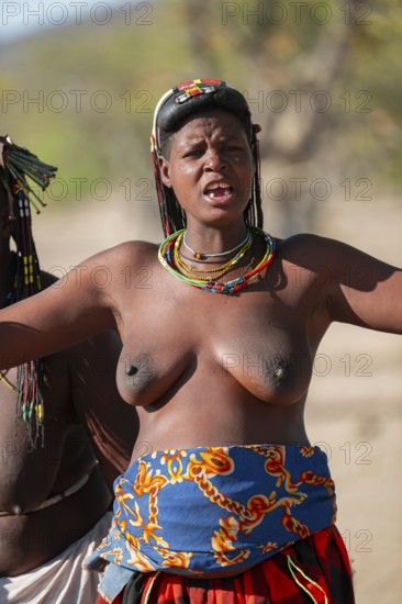 Traditional dance, brightly decorated woman of the Hakaona tribe, also Havakona or Hakawona, near Opuwo, Kunene, Namibia
