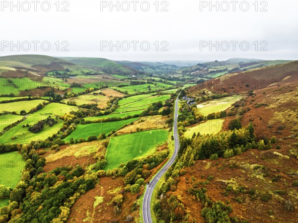 Autumn colours of Farms over River Wye and Road A470 from a drone, Llanidloes, Powys, Montgomeryshire, Wales, UK