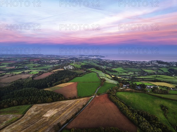Sunset of Devon Farms and Fields over Berry Pomeroy from a drone, Totnes, England, United Kingdom
