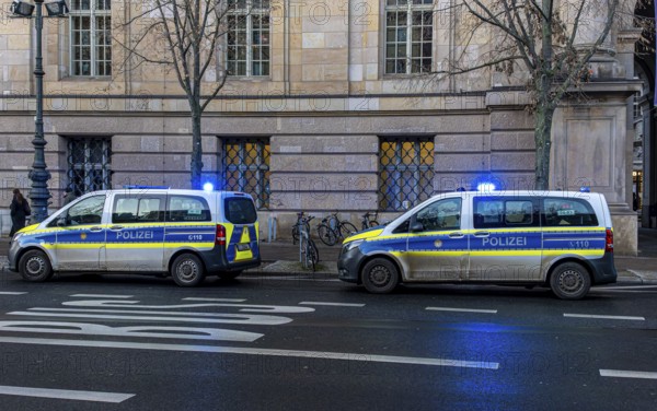Police vehicles with flashing lights switched on, special operation at the Berlin State Library, Unter den Linden, Berlin, Germany