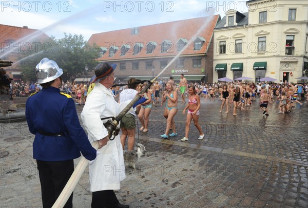 A popular event every year in August is when the Ystad Volunteer Fire Brigade takes the old fire pump made in 1850 to the square and sprays water on the assembled children, who are then baptized as true Ystad residents. Ystad, Skåne County, Sweden, Scandinavia
