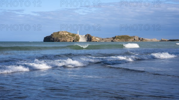 Castlepoint Beach and Castlepoint Lighthouse, ocean, waves, surf, sandy beach, rocks. Castlepoint, Wairarapa Coast, Wellington Region, North Island, New Zealand