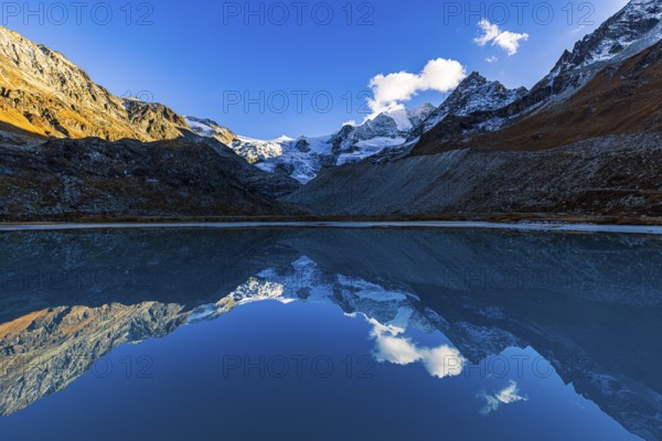 The Moiry glacier and mountain peaks are reflected in Lac de Chateaupre, Val d'Anniviers, Valais Alps, Canton of Valais, Switzerland