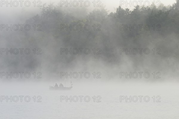 Hennesee, fog, rising clouds of fog, anglers in the boat, Hennetalsperre, Sauerland-Rothaargebirge nature park Park, North Rhine-Westphalia, Germany