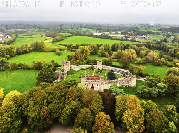 Autumn Colours over ruins of Caldicot Castle from a drone, Caldicot, Monmouthshire, Wales, UK