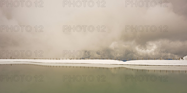 Another onset of winter in May, Riezler Alpsee, an artificially created lake, snow pond, feeds the snow cannons that completely snow the slopes of the Fellhorn and Kanzelwand cable cars, Allgäu Alps, Vorarlberg, Austria