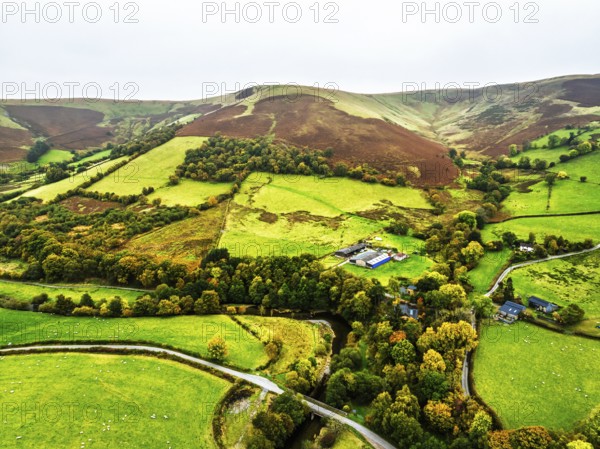 Autumn colours of Farms over River Wye and Road A470 from a drone, Llanidloes, Powys, Montgomeryshire, Wales, UK