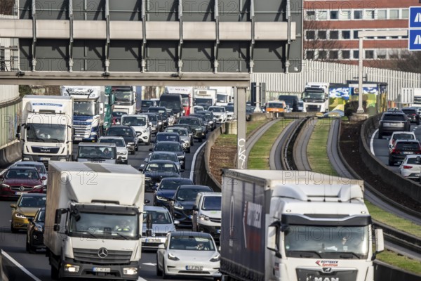 Heavy traffic on the A40 motorway, Ruhrschnellweg, height of the Essen-Ost motorway junction, looking east, 6-lane motorway, with 2 bus lanes in the middle, rush hour traffic, North Rhine-Westphalia, Germany