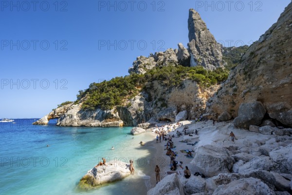 Light blue clear sea on a dream beach on Cala Goloritzé, picturesque rocky coast, steep coast with rock pin L'Aguglia, Golfo di Orosei, Baunei, Sardinia, Italy
