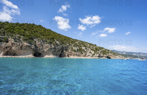 Clear blue water and picturesque rocky coast, Cala Luna cliffs and beach, Golfo di Orosei, Baunei, Sardinia, Italy