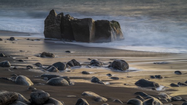 Sunset, waves and rocks in the sea, Praia Formosa, Madeira, Portugal
