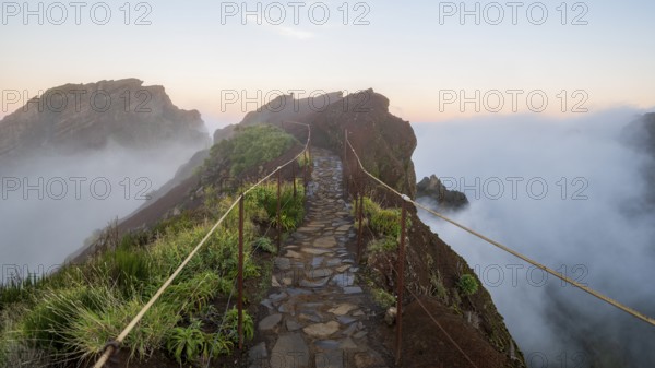 Sunrise at Pico do Arieiro, clouds of fog sweep over mountain peaks, sea of fog, hiking trail PR1, Madeira, Portugal