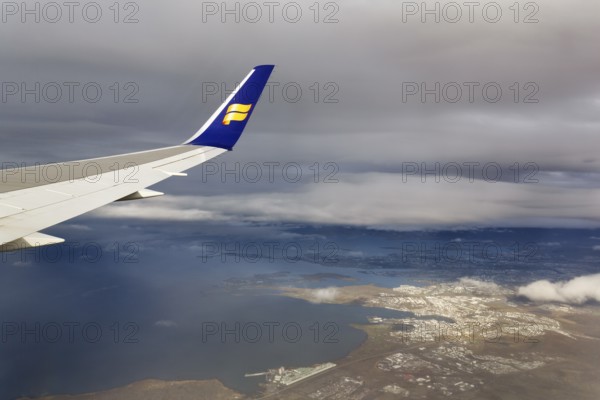 Wing, airplane, Icelandair airline logo, flying to Boston, view of Reykjavik, aerial view, Iceland