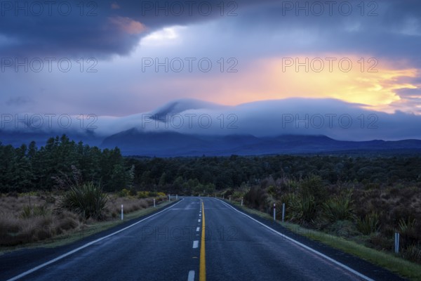 Mount Ngauruhoe in the morning at sunrise with glowing clouds, road SH 47. Tongariro National Park, North Island, New Zealand