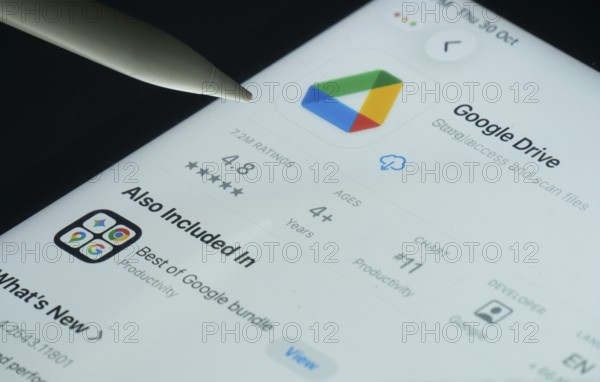 Dhaka, Bangladesh- 30 Oct 2025: Google Drive app on a iPad screen with a pen pointing at the install option