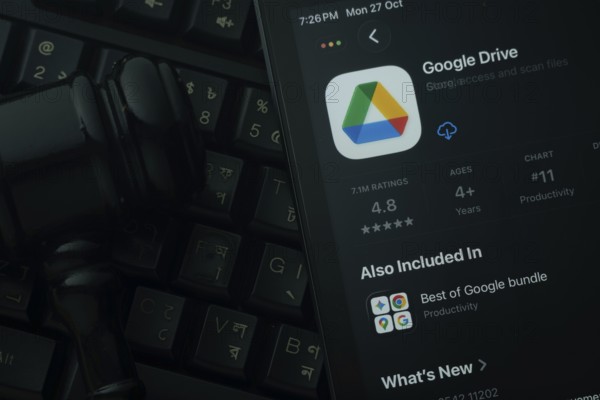 Dhaka, Bangladesh- 28 Oct 2025: An iPad displaying the Google Drive app against a judge's gavel and dark keyboard background