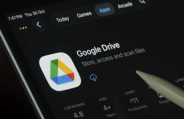 Dhaka, Bangladesh- 30 Oct 2025: Google Drive app displayed on a iPad screen in dark mode with a digital pen pointing at it