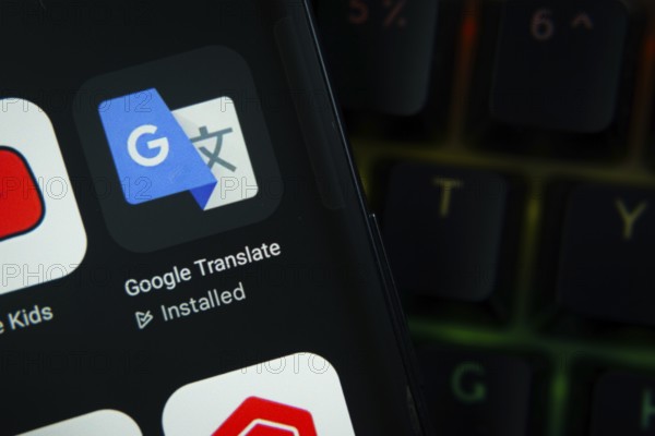Dhaka, Bangladesh- 27 July 2025: Close-up of smartphone screen showing the Google Translate app icon with a dark interface