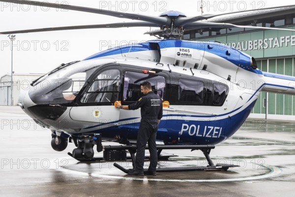 Helicopter from the Baden-Württemberg Police team in front of the hangar at the airport. Airbus Helicopters H145. Stuttgart, Baden-Württemberg, Germany