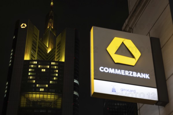 A yellow heart glows on the façade of the Commerzbank Tower in Frankfurt am Main at Christmas time in the evening, Frankfurt am Main, Hesse, Germany