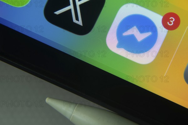 16 Nov 2025- Dhaka, Bangladesh: Messenger and other app icons with a digital pen on a iPad screen